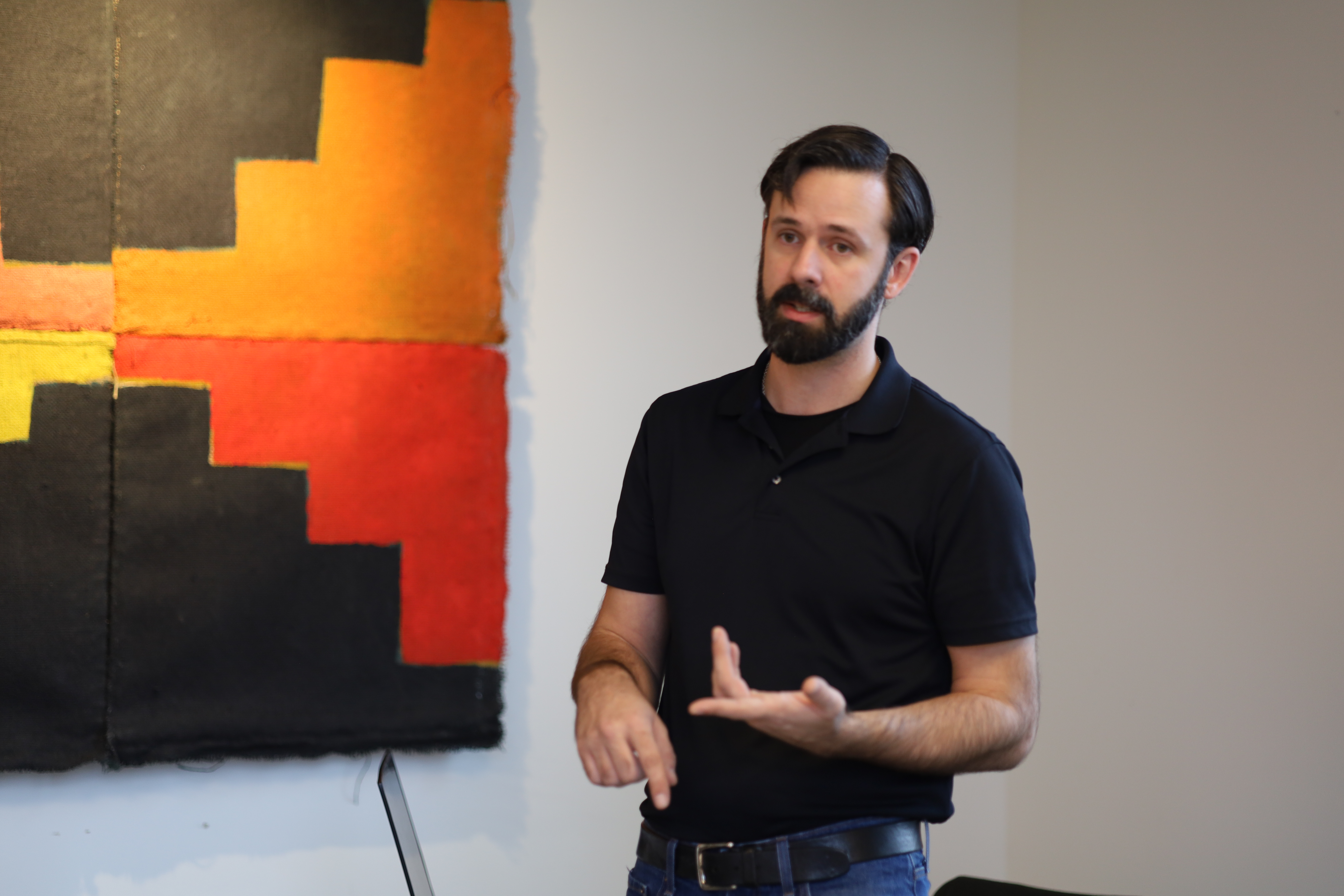 Christopher Nesbit standing in front of stepped artwork